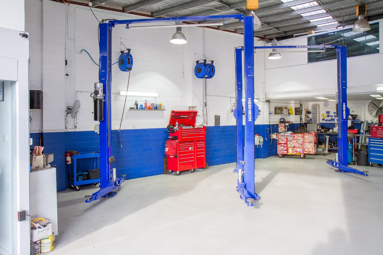 Inside the Simply Subaroo workshop — clean floor, blue hoists